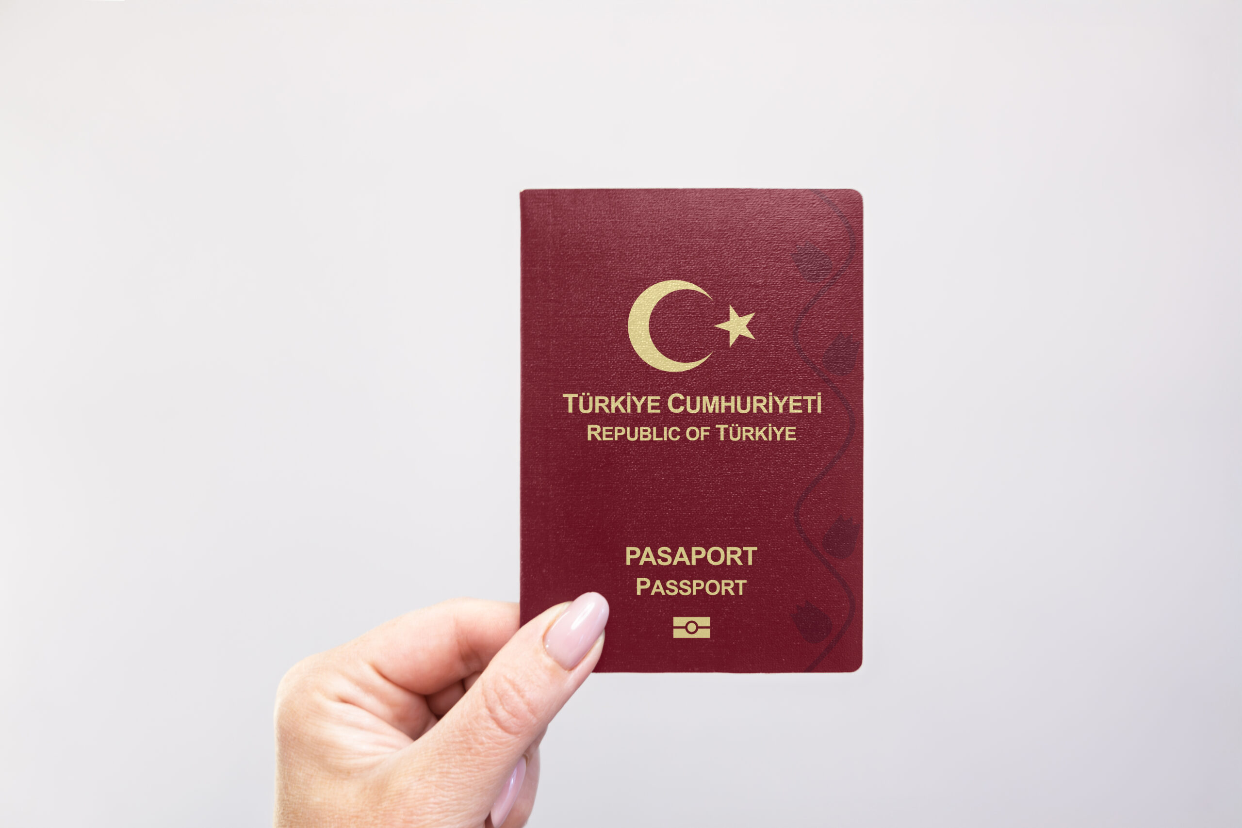 Close-up of a Turkey passport held in hand against a plain white background. Astana, Kazakhstan, 26 october 2024